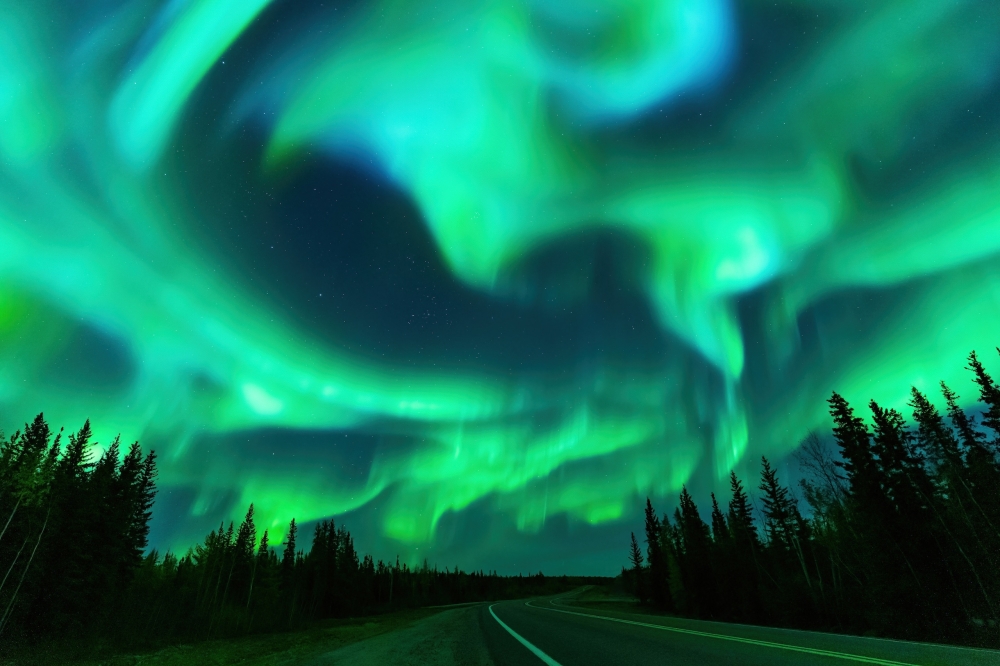 Northern lights above an empty road